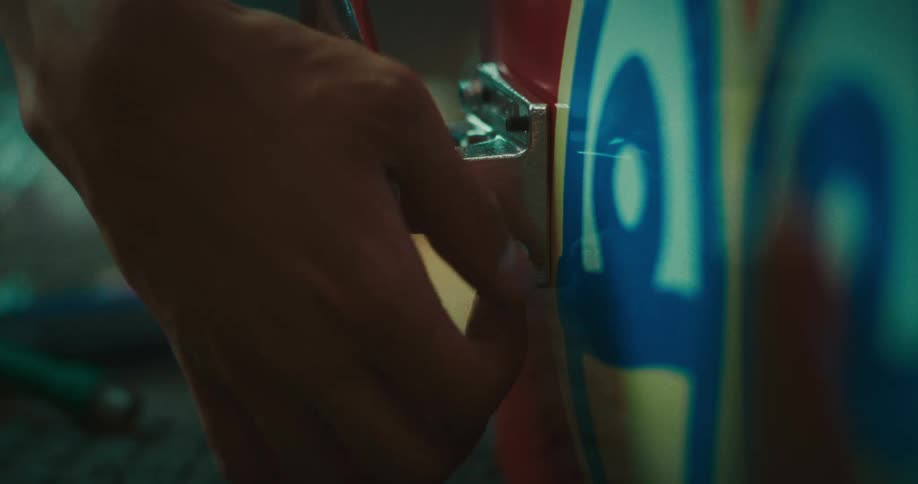 Person tightens a screw on a machine by hand