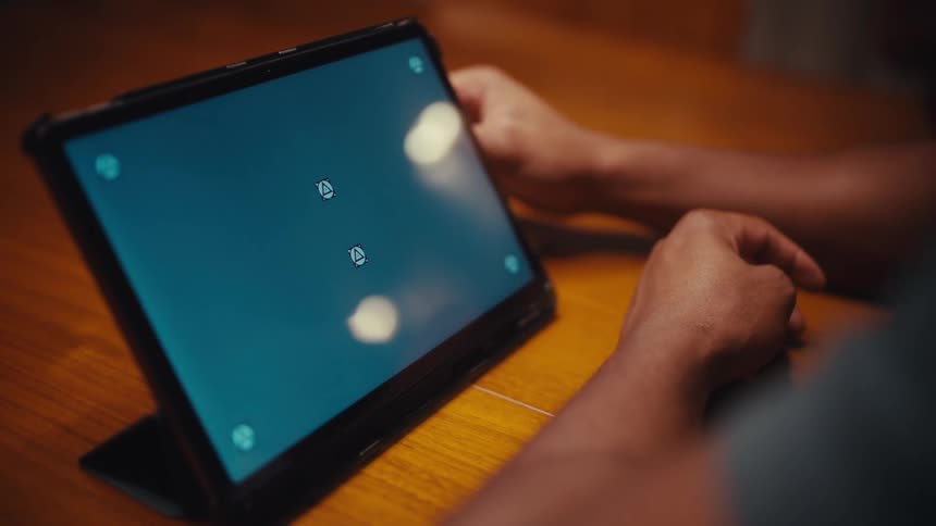 Man sitting at a table with a tablet computer with a replacement screen