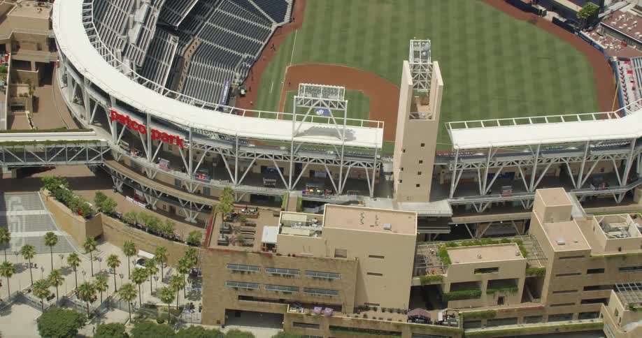 Cars drive down a road in front of Petco Park baseball stadium in San Diego, California
