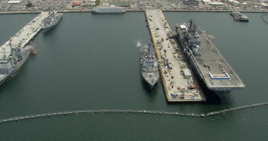 Naval ships sit docked at piers in San Diego, California