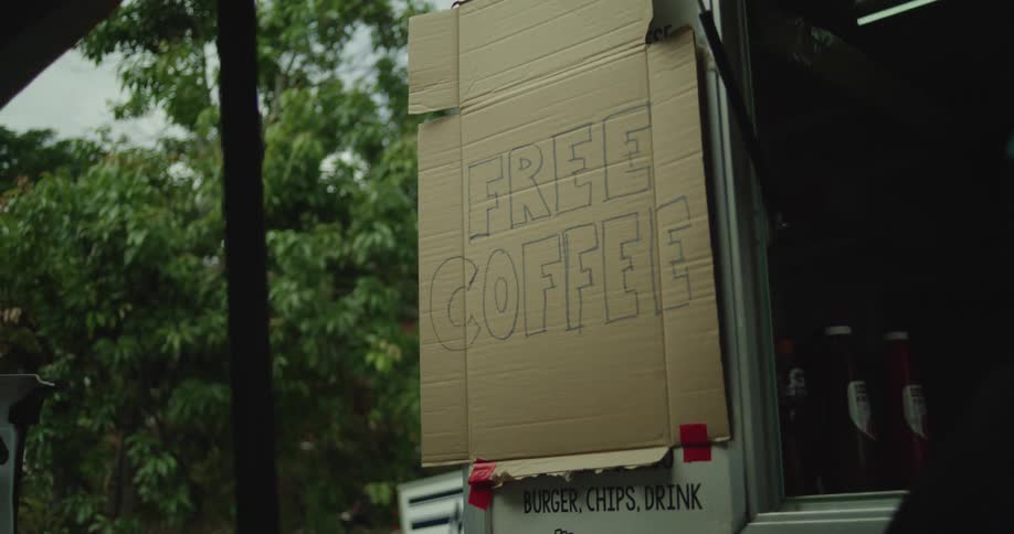 Handwritten signs are on the food truck