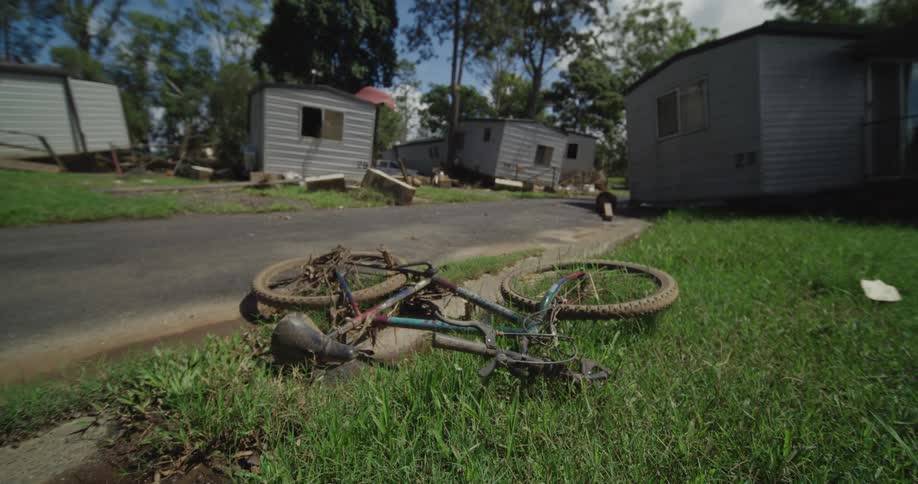 A view of a destroyed bike and houses