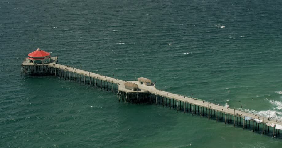 An ocean pier extends into the Pacific Ocean in Huntington Beach, California