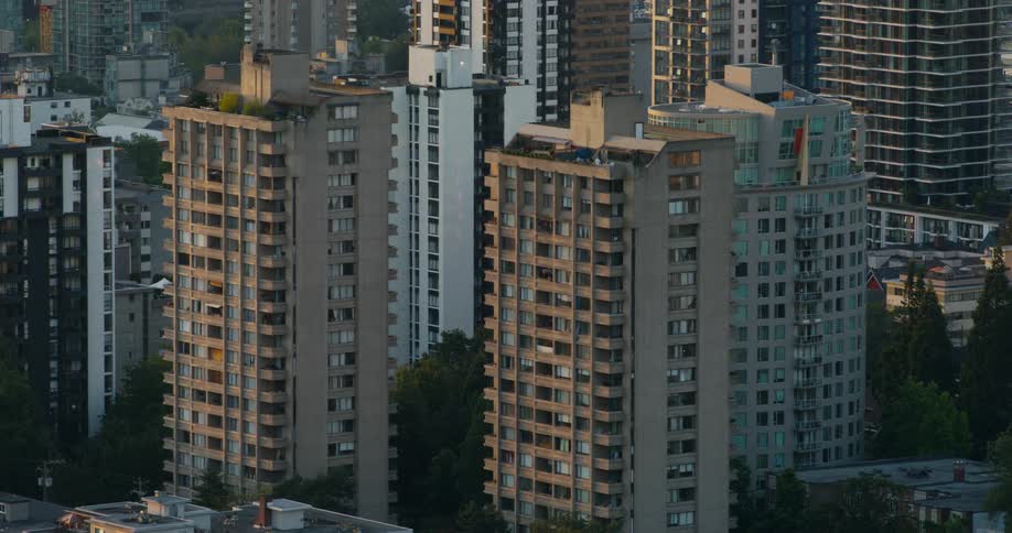 Two high rise buildings on a neighborhood of a metropolitan area outdoors during dusk or dawn