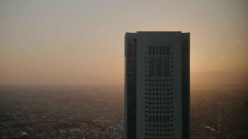 Building in a metropolis with the sunset