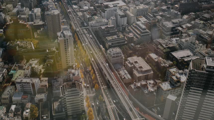 Dense traffic on a street of a metropolitan area seen through glass outdoors during day time