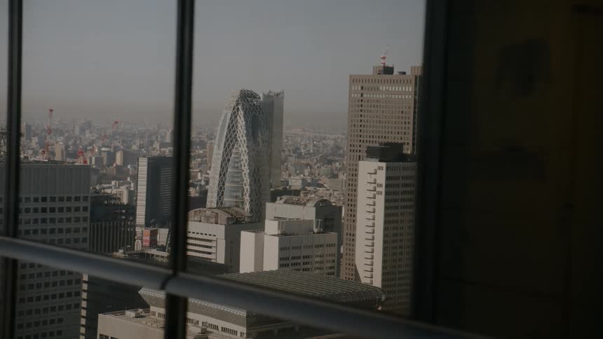 Urban view with tall buildings seen through a glass window