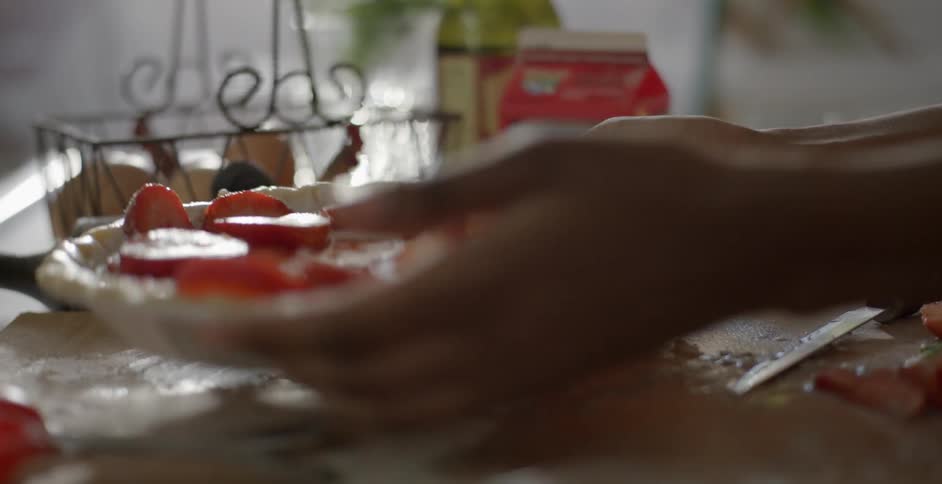 A person prepares a pie in a kitchen