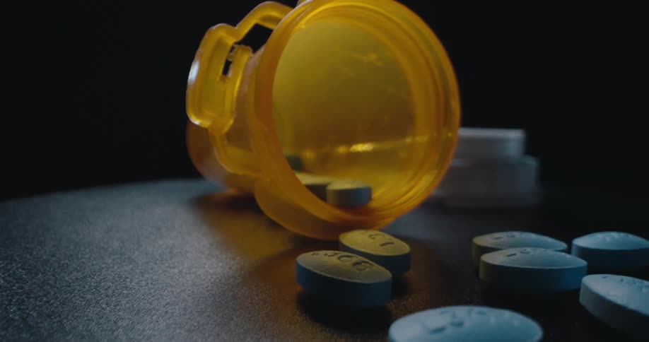 Medicine tube with tablets scattered on a surface