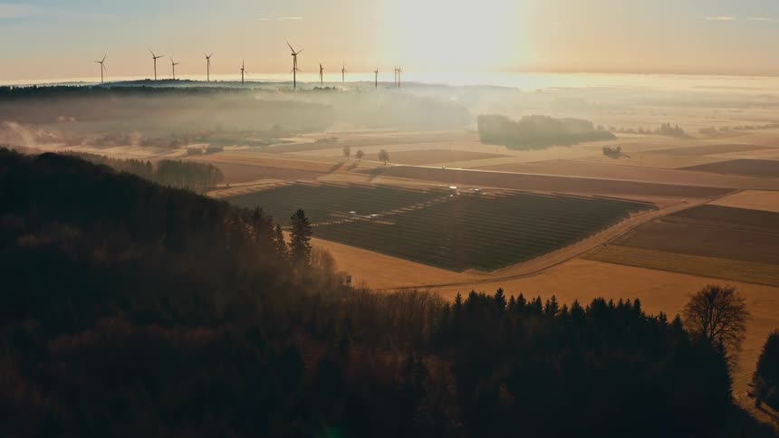 The sun is rising on the wind farm