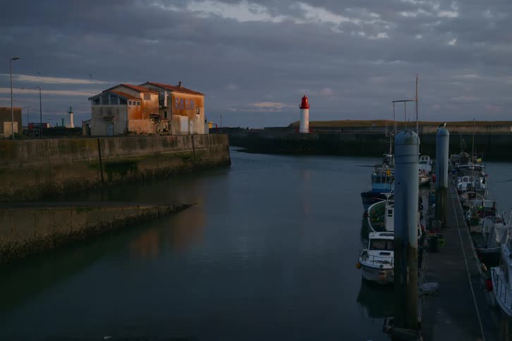 Some boats docked at a dock on the water