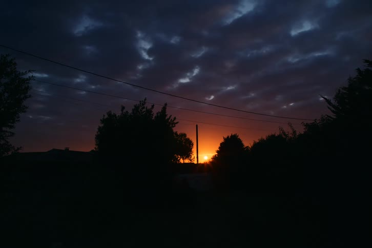 Sunrise on the horizon in a cloudy sky