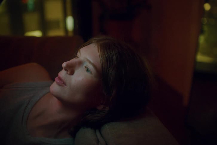 A portrait of a woman laying around resting