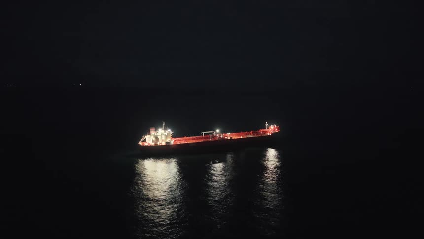 Freight ship in the middle of the ocean at night