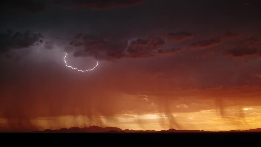 A storm with lightning at sunset
