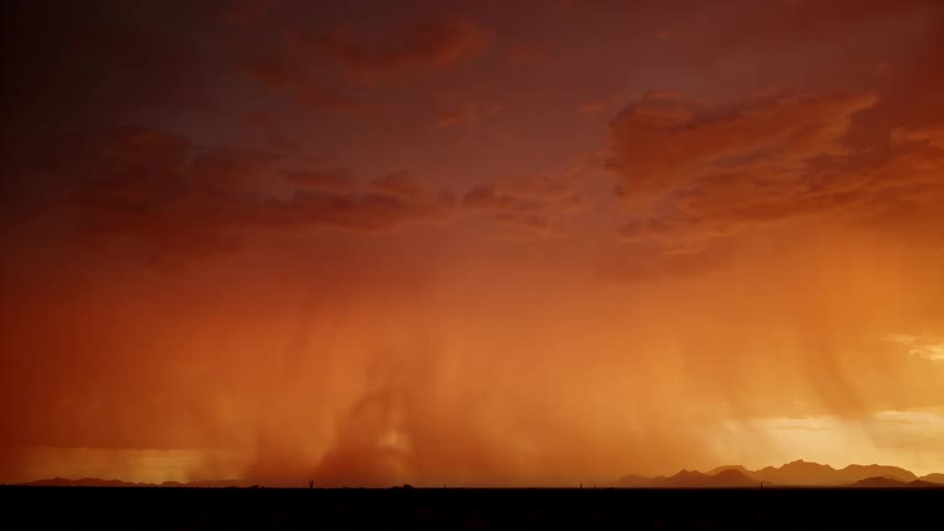 Thunderstorm with lightining and tornadoes on the sky over a field with mountains on the background outdoors during dusk or dawn