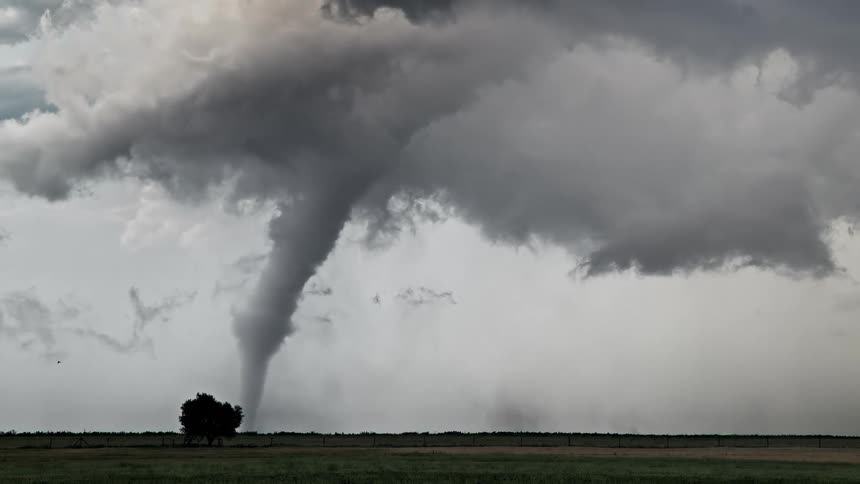 A tornado ripping through a field