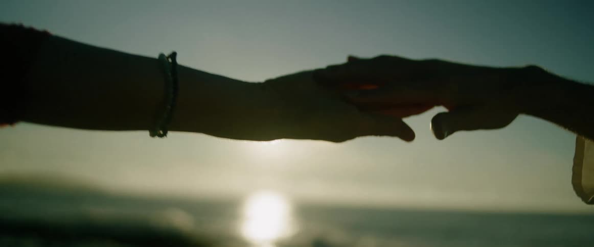 Two people holding hands outdoors
