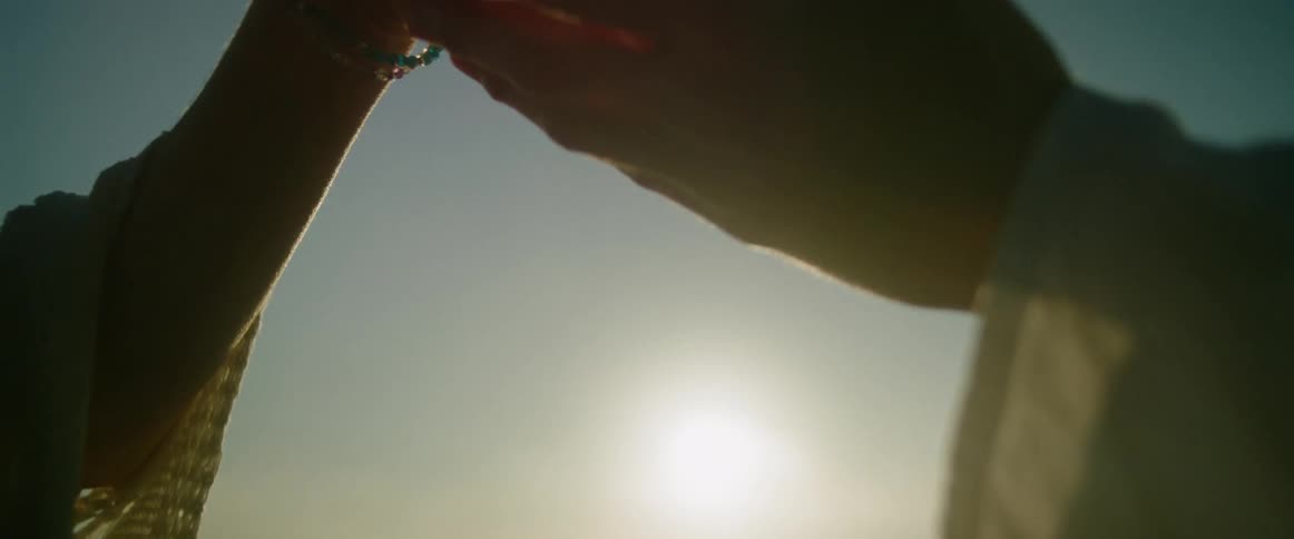Two people reaching out and holding hands