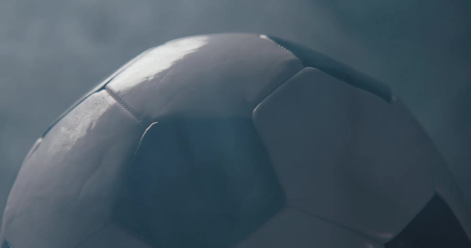 Black and white ball with smoke surrounding it