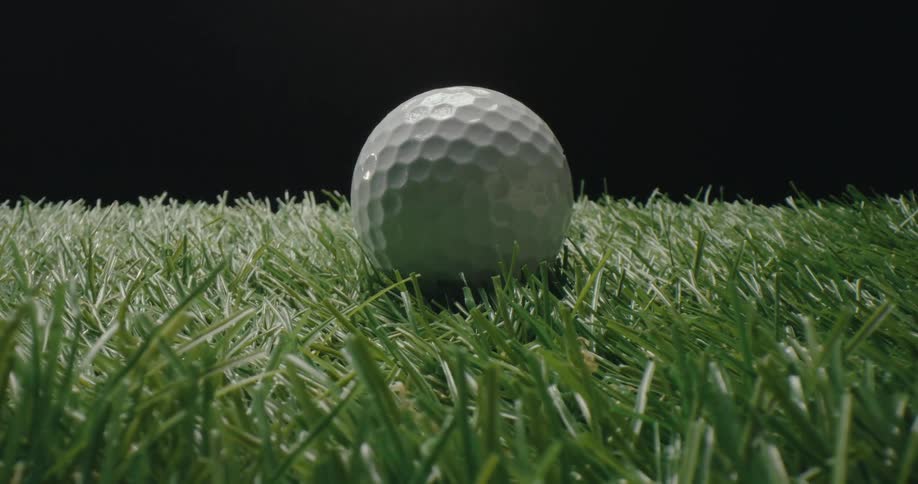 Golf ball stationary on artificial turf