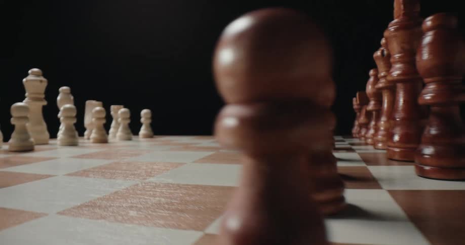 Rustic chess pieces arranged on a chessboard