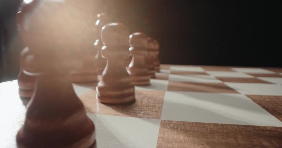 The chess pieces are lined up on the board
