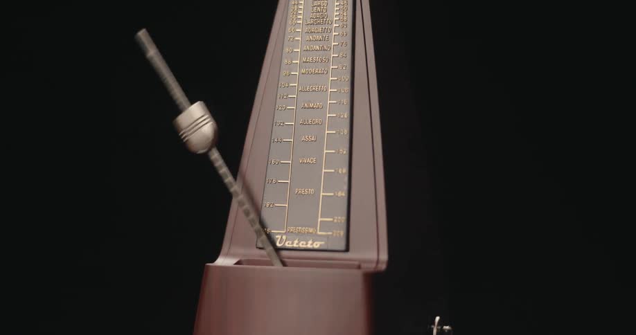 A metronome with its needle passing back and forth