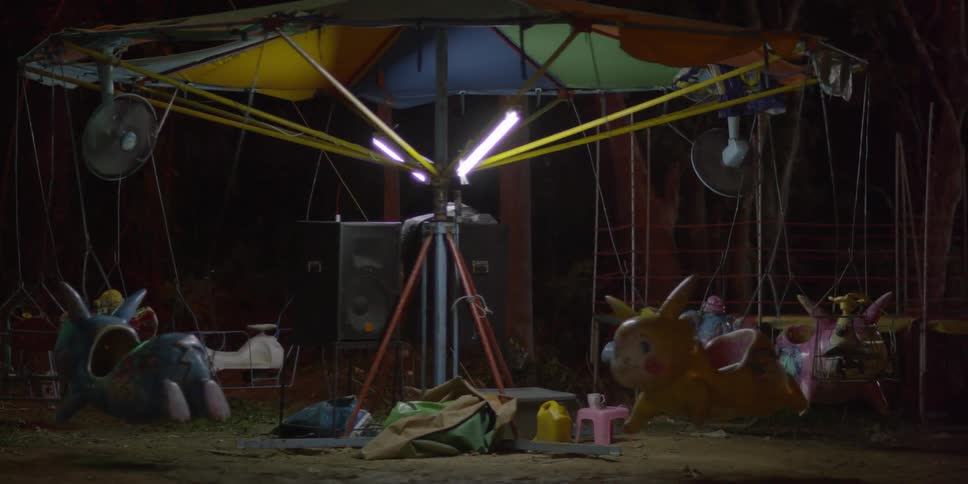 An old children's merry go round spinning at night