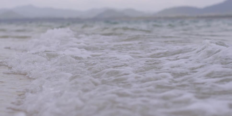 Waves foam as they come to shore