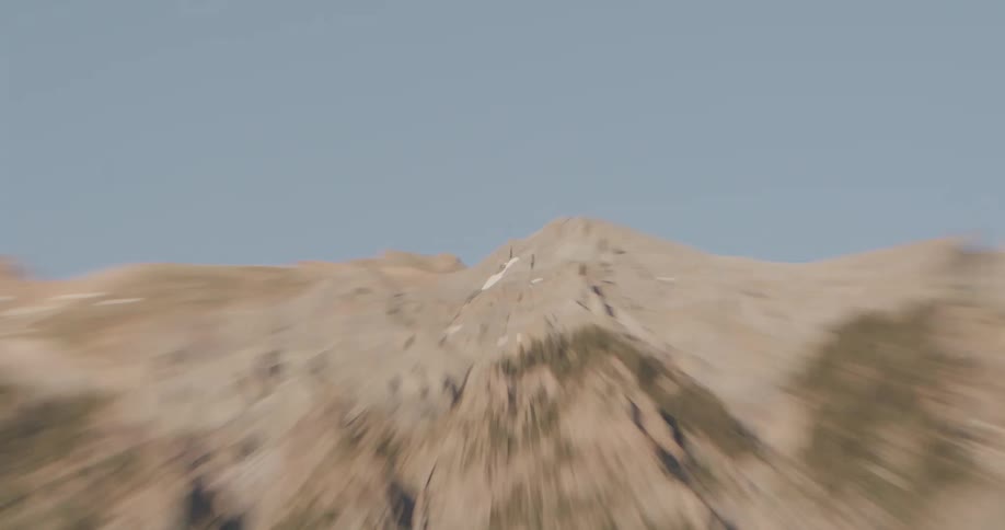 A wide shot of a sunlit mountain range is followed by a dramatic highspeed zoom that settles on a single rugged peak against the clear blue sky