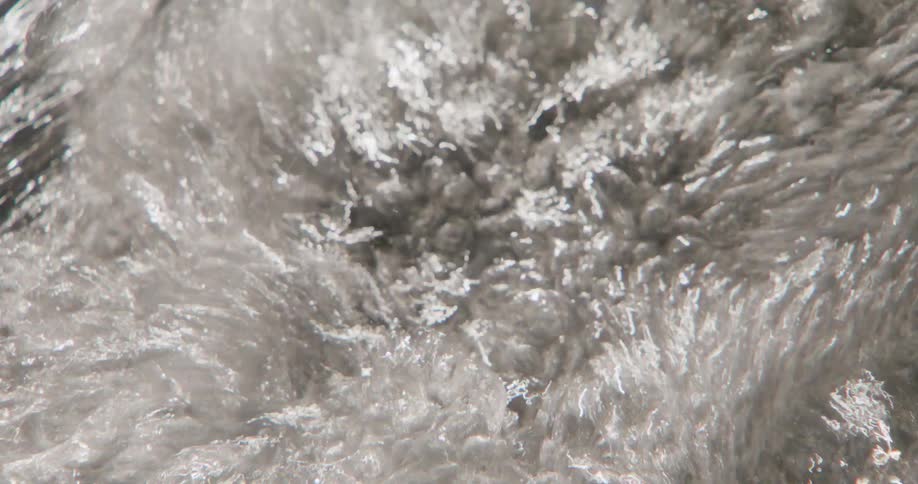 Water with bubbles flowing in the river