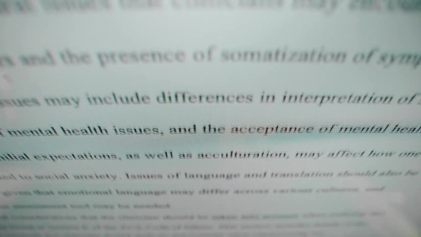 A closeup shot pans upward over a digital document visible on a computer screen