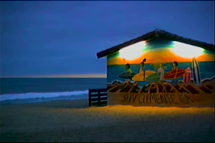 Beach house lighting up at dusk