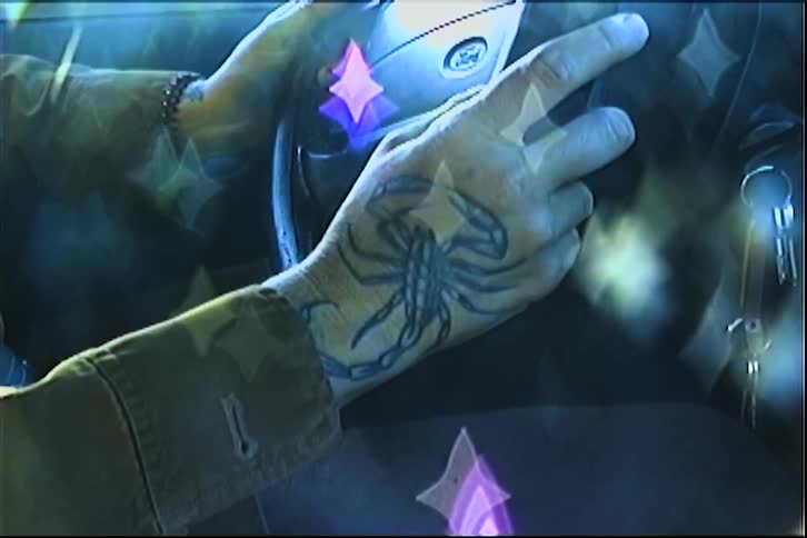 Tattooed hands on fiat steering wheel with translucent stars overlaid in surreal style