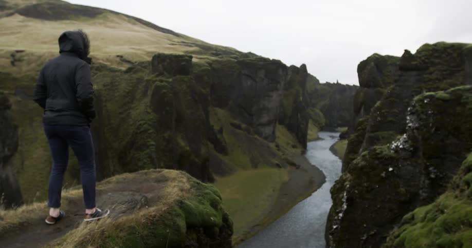 Person walks to a cliff edge