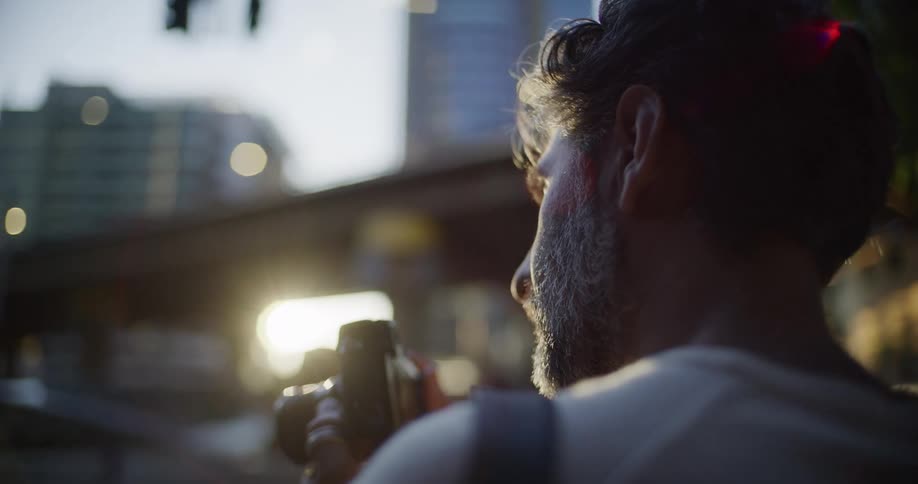 A man using a camera outdoors