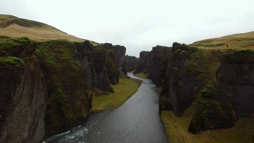 A river cuts through a green valley