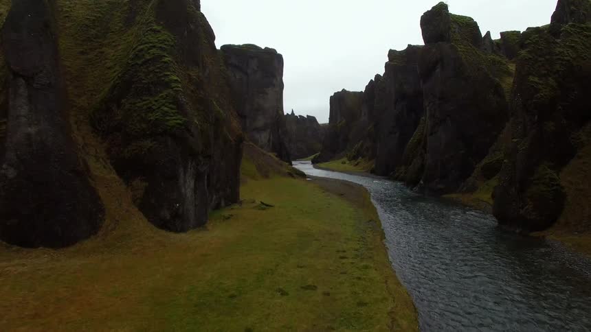 A river surrounded by a large rocky cliff