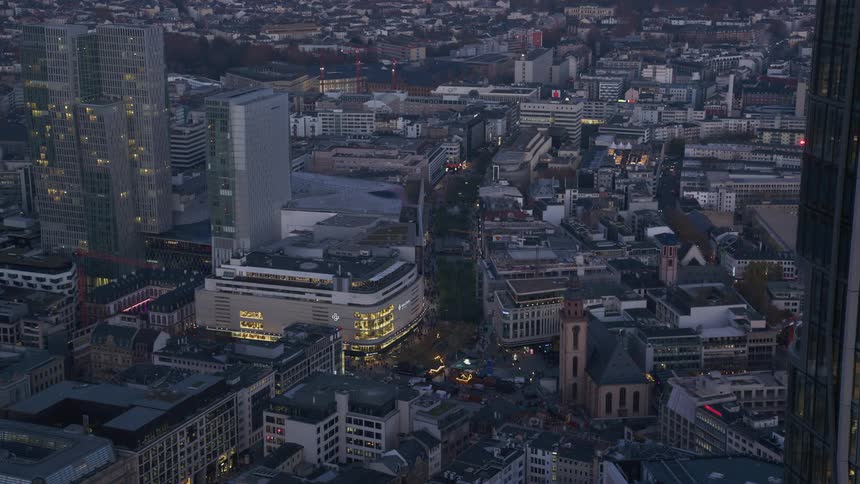 From a high vantage point the sprawling city unfolds at dusk its streets and buildings coming to life with a tapestry of glowing lights