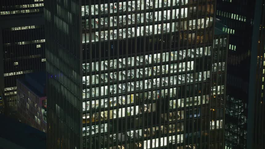 Most of the windows in the building are lit at night
