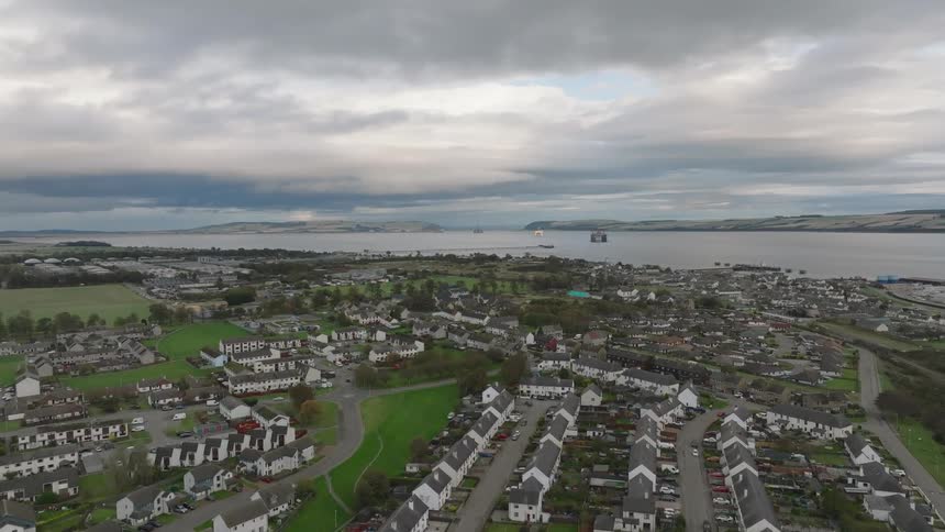 A suburb is positioned next to a large body of water