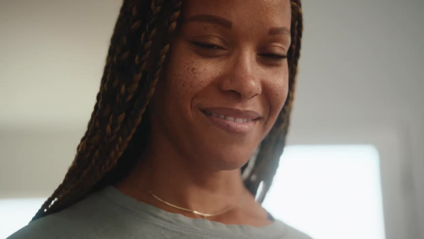 Smiling woman sticking a sticker on her tshirt