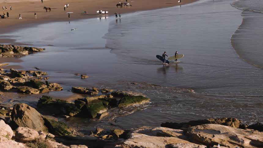 Surfers entering the sea