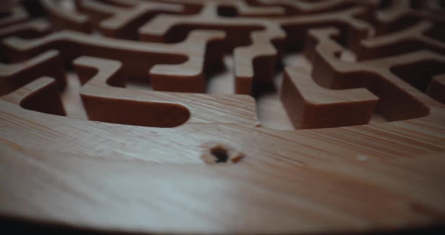 Closeup of a wooden art maze slowly turning