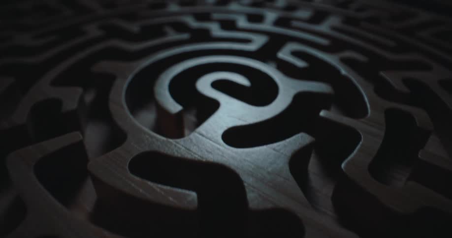 A metal disk has designs carved into it