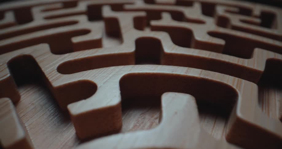 Blonde wood forms a smooth sided maze on a circle shaped surface