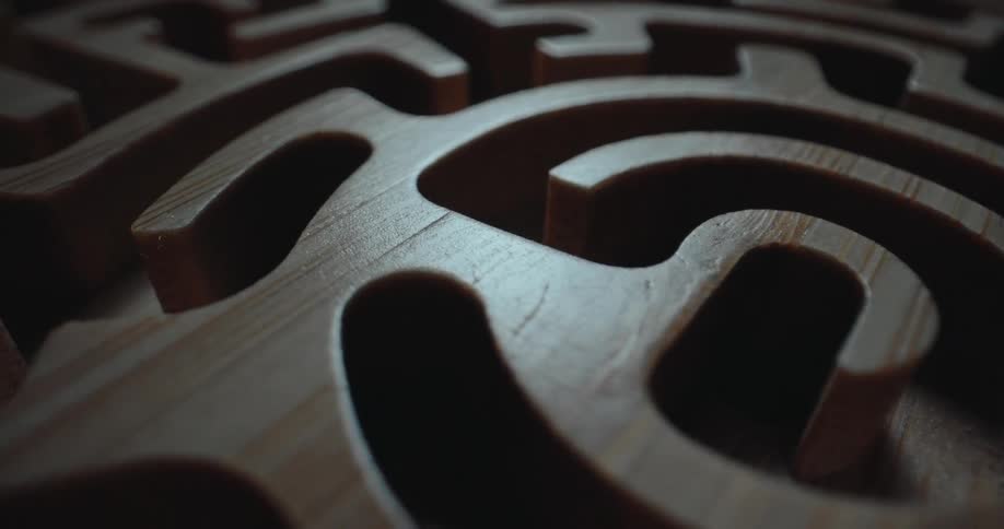 A close up of a woodne carved maze