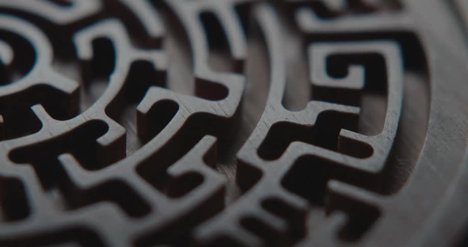 A brown disk with a maze fades as it gets dark