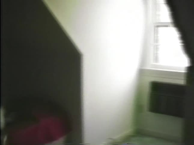 Child jumping on a bed in a residential bedroom